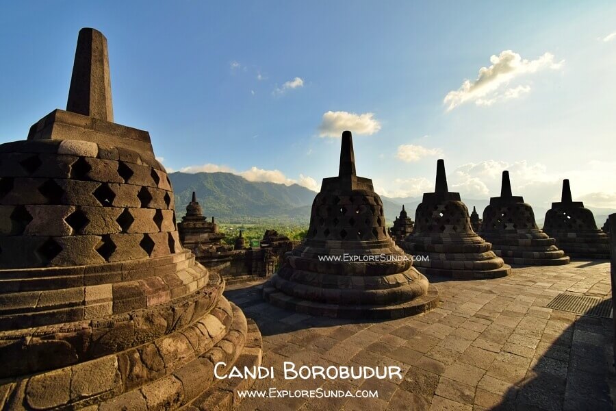 The circular terrace of Borobudur temple with rows of stupas and view of Menoreh Hill.